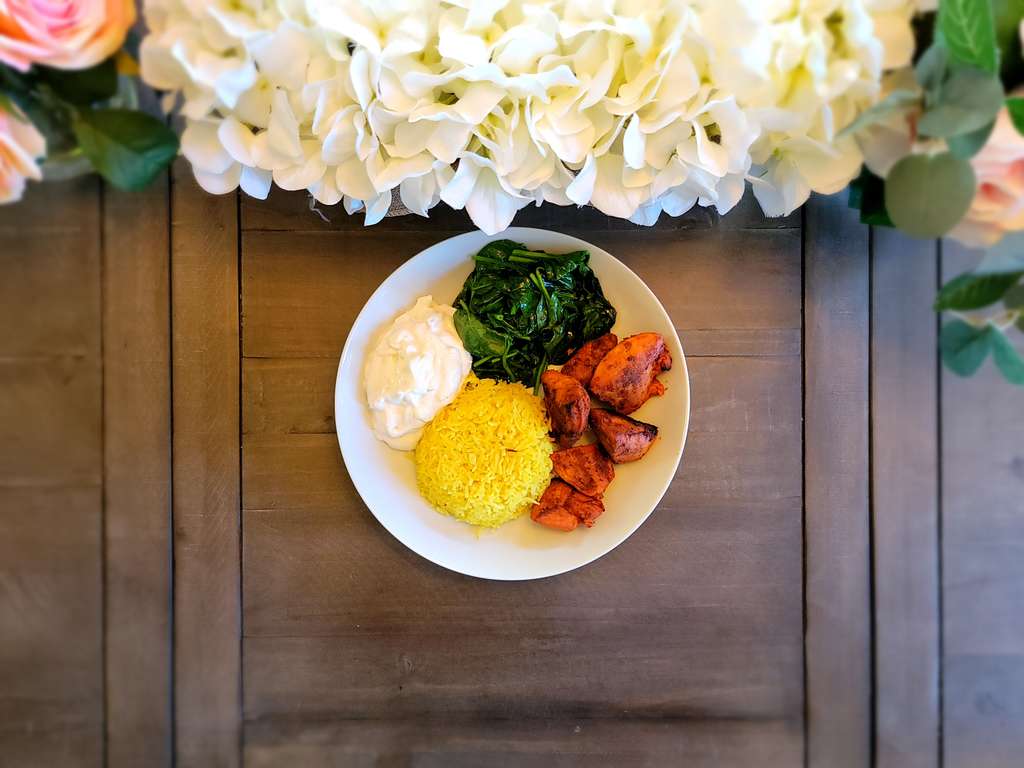 Grilled Tandoori chicken with Mediterranean rice with yogurt tzatiziki and sauted Spinach 