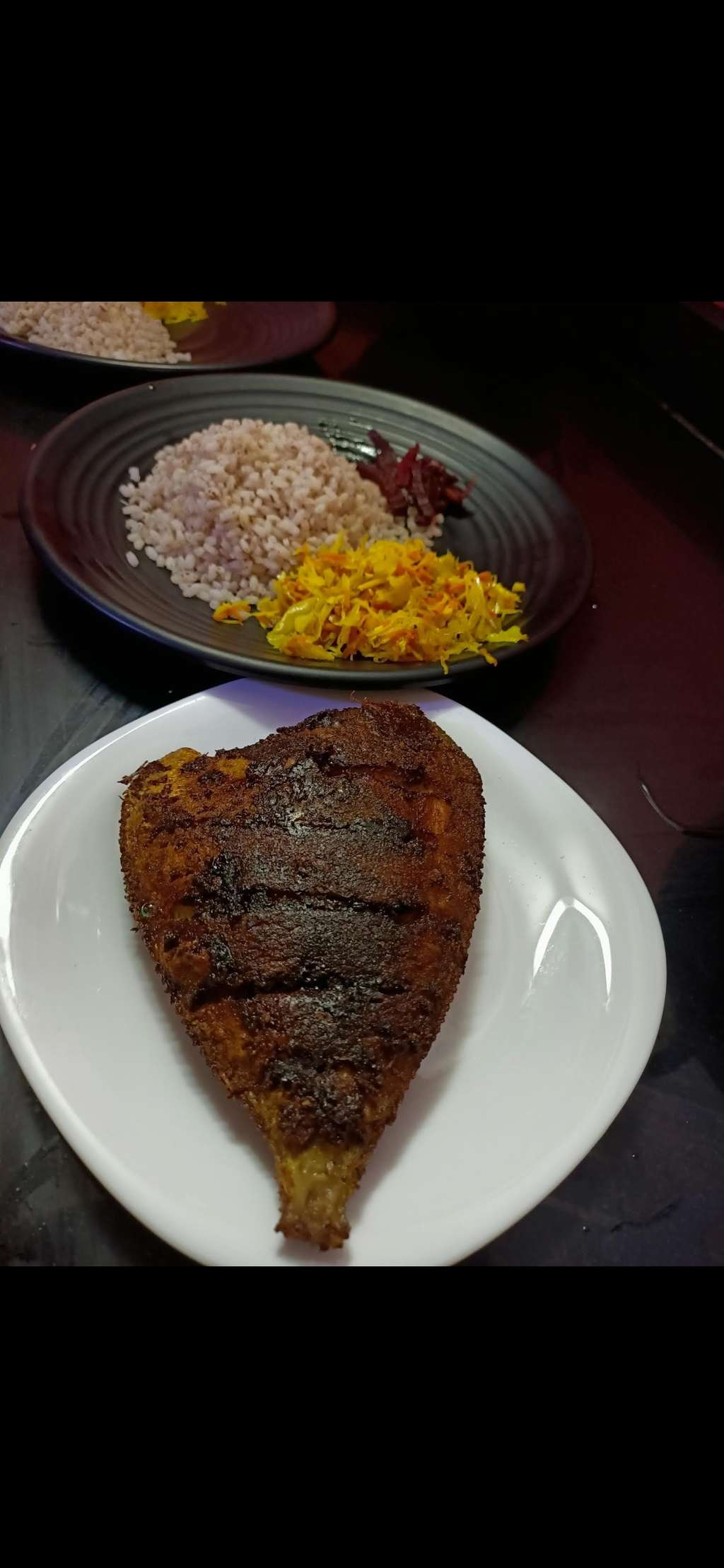 Shallow fried fish in coconut oil with lots of curry leaves