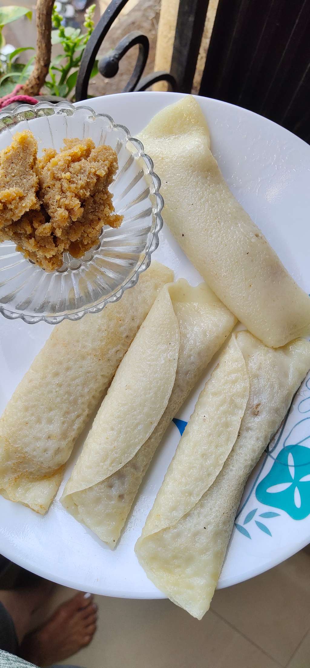 Crepes stuffed with jaggery flavored coconut
