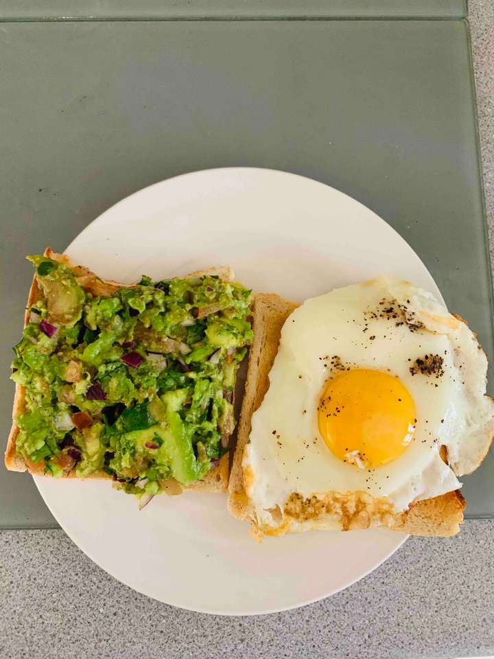 Bread toast with guacamole and egg